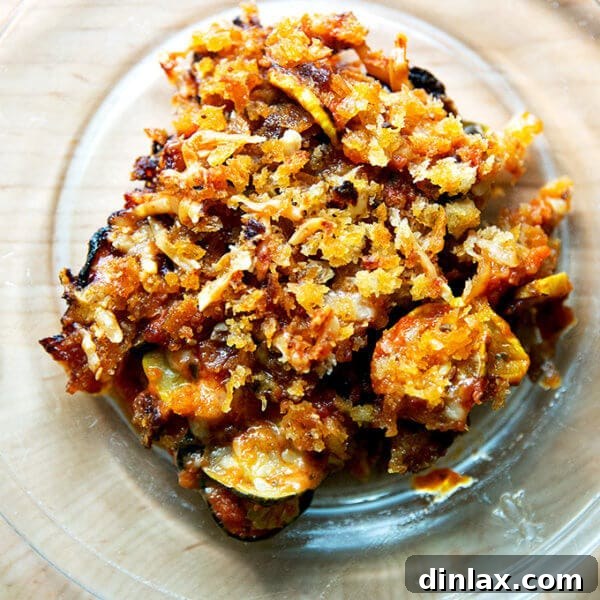 A slice of just-baked zucchini parmesan on a plate, garnished with fresh basil.