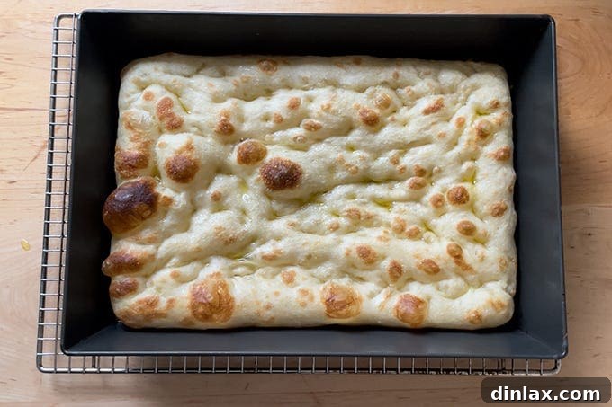 A parbaked Detroit-style pizza crust in the oven.
