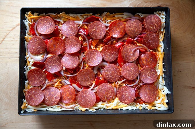 An unbaked Detroit-style pizza, ready for the oven.