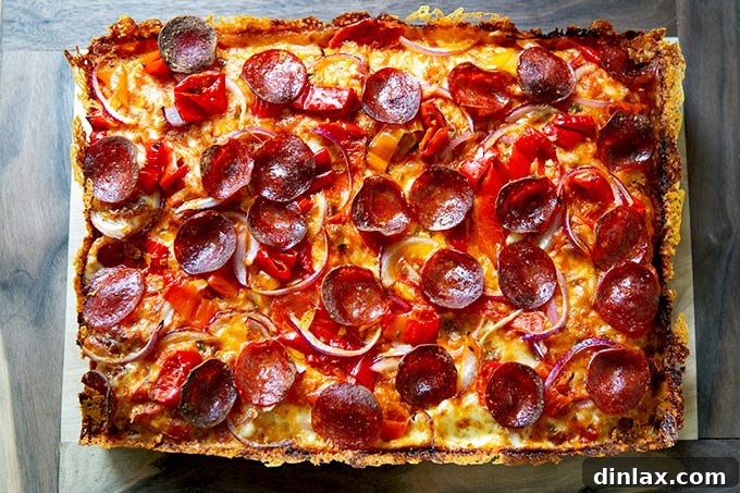 A just-baked Detroit-style pizza on a board.
