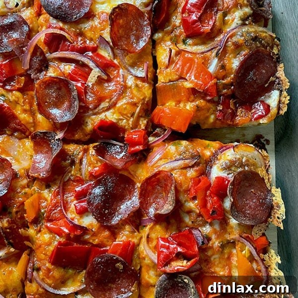 A just-baked Detroit-style pizza on a board.