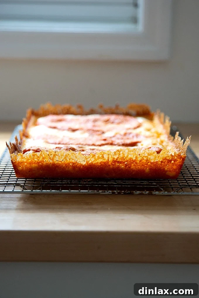 Just baked Detroit-style pizza with a lacy, frico crust.
