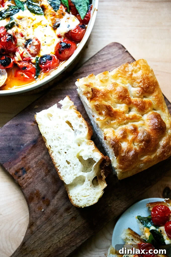 Warm Feta & Burst Tomato Bake 12 A slice of focaccia on a cutting board.