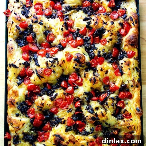A large sheet pan holding just baked pissaladière, golden brown and enticing.