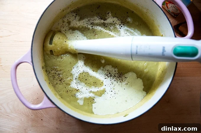 Puréeing potato leek soup with an immersion blender.