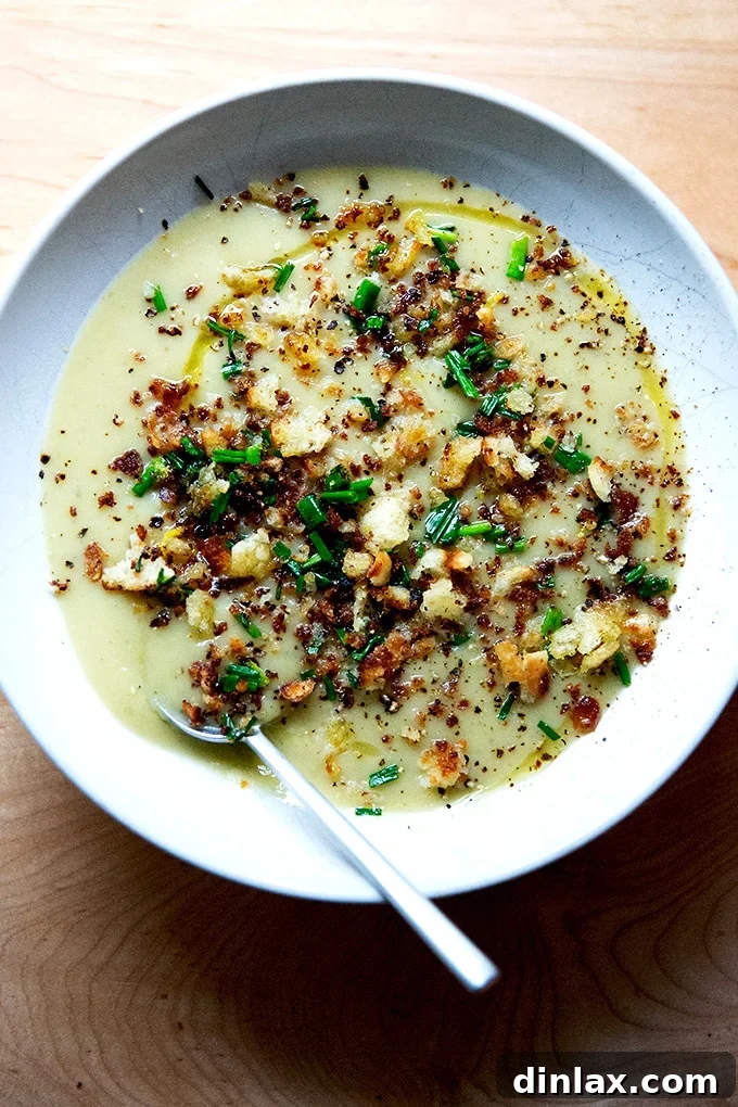 A perfectly garnished bowl of homemade potato leek soup.