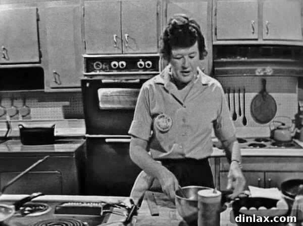 Julia Child smiling on the set of her iconic cooking show, The French Chef.