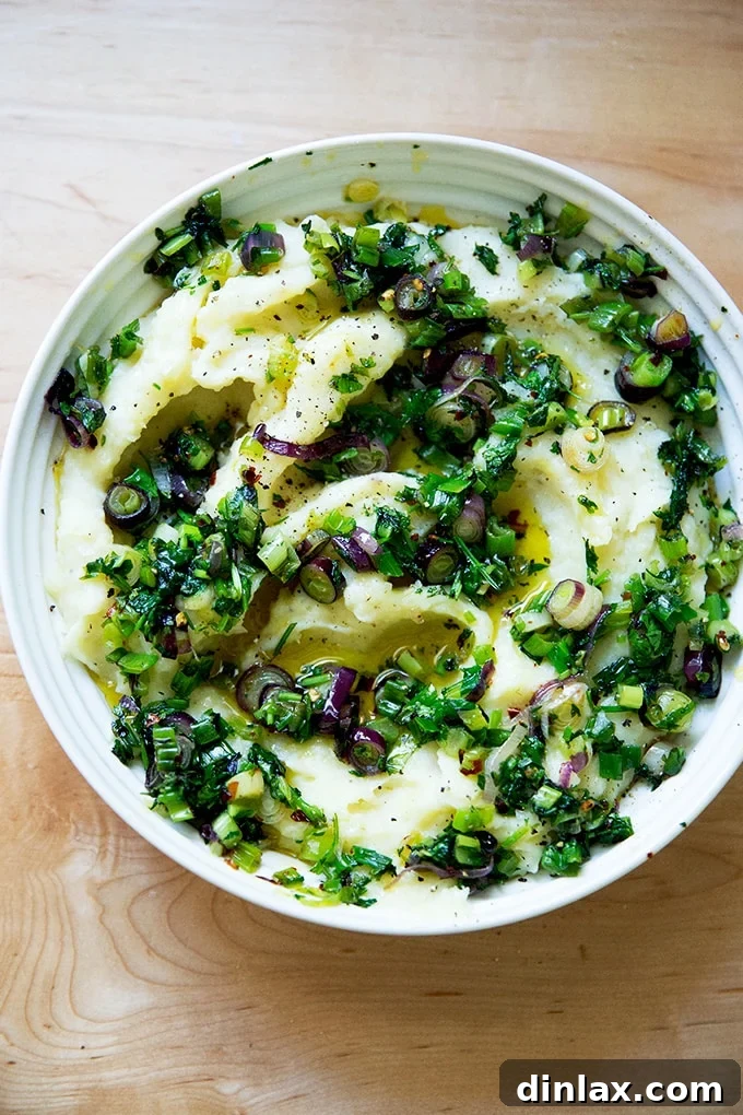 A beautifully presented bowl of herby buttermilk mashed potatoes, topped with the vibrant scallion and cilantro sizzle.
