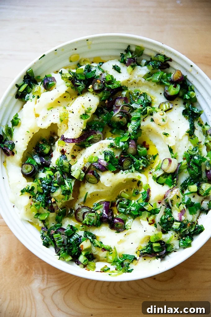 A bowl of herby buttermilk mashed potatoes, featuring roasted garlic, creating a delightful blend of flavors and textures.