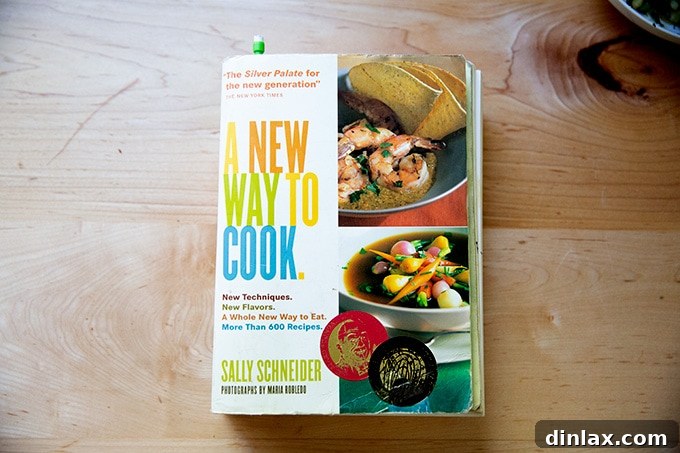 A copy of the cookbook 'A New Way to Cook' resting on a kitchen counter, highlighting the recipe's origin.