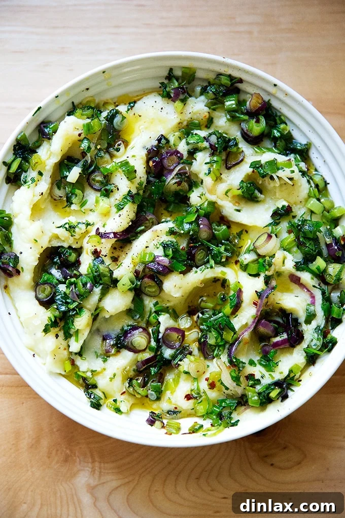 A large, inviting bowl of herby buttermilk mashed potatoes, perfectly garnished and ready to be enjoyed.