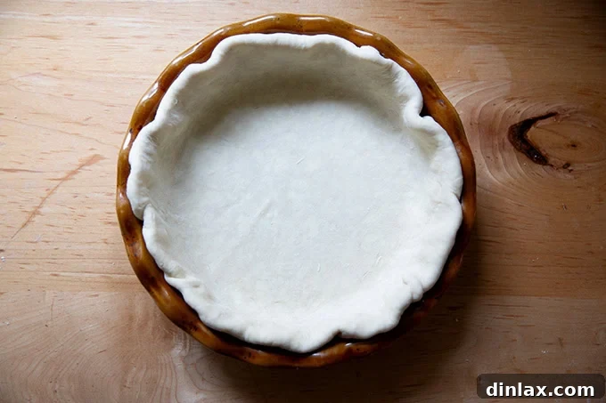 A pie plate fitted with pie dough.