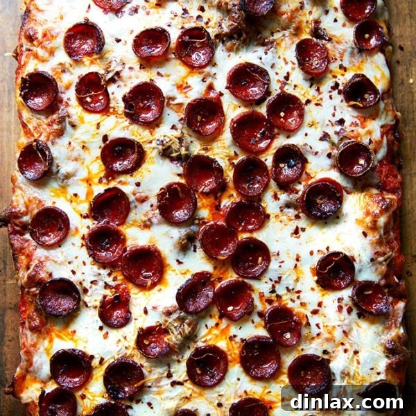 Freshly baked Sicilian-style pepperoni pizza, showcasing a golden crust and melted cheese, ready to be enjoyed.