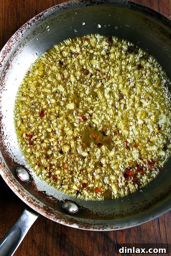Sautéing Garlic for Pasta Sauce Garlic cloves gently bubbling in hot olive oil, releasing their aromatic flavors
