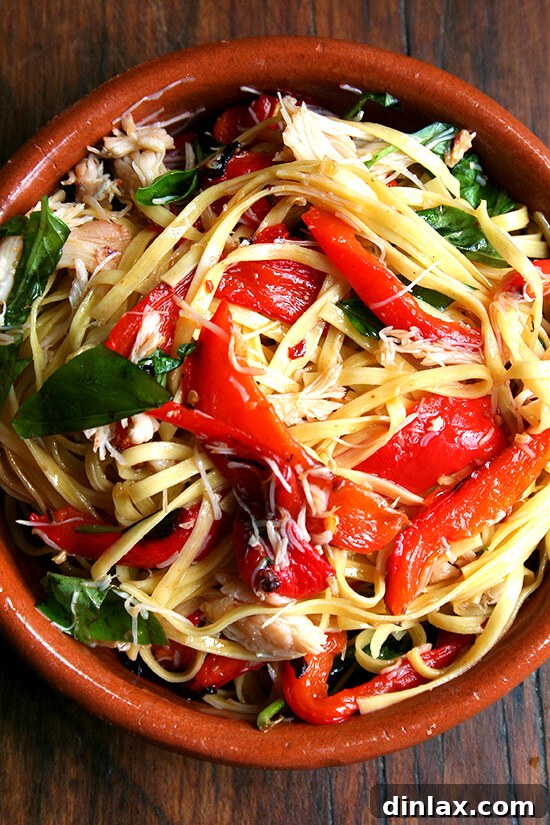 A Hearty Summer Linguine Dish Close-up of the delicious summer linguine dish, highlighting the crabmeat, roasted peppers, and fresh basil
