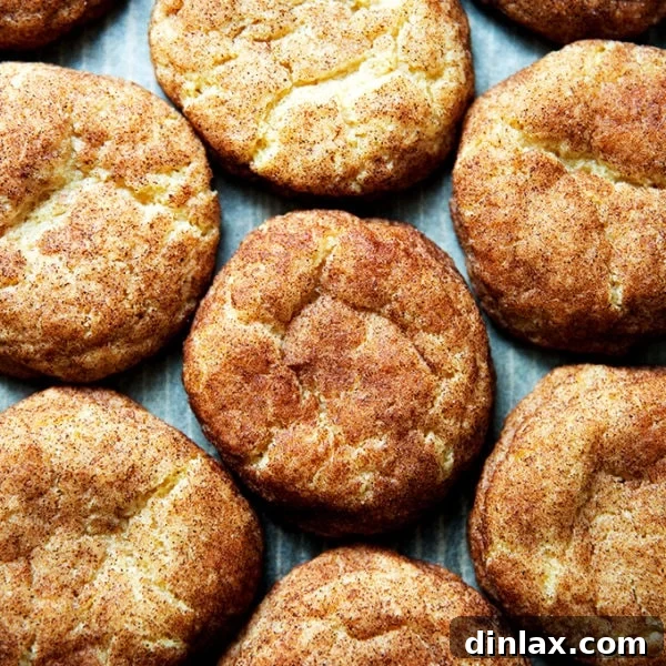 Freshly baked brown butter snickerdoodles arranged on a sheet pan.