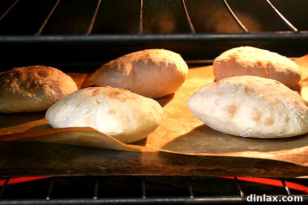 Piadines in the oven, showing slight puffing