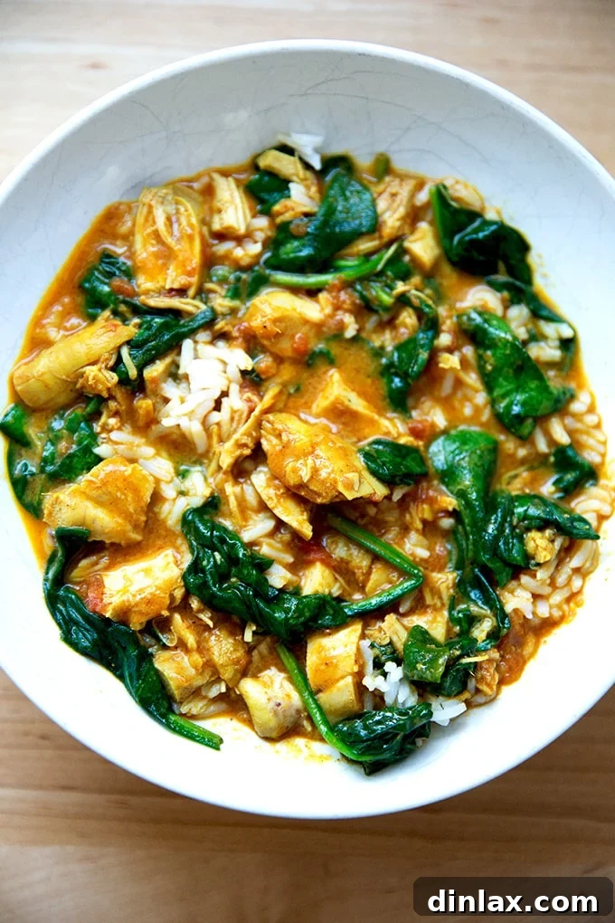 Effortless Butter Chicken and Chickpeas Instant Pot or Stovetop 16 A beautifully plated bowl of butter chicken with spinach, served alongside a portion of basmati rice.