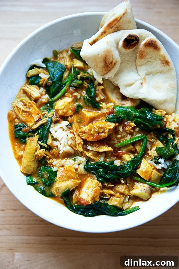 Effortless Butter Chicken and Chickpeas Instant Pot or Stovetop 17 A complete meal of butter chicken with spinach, basmati rice, and a side of fluffy naan bread.