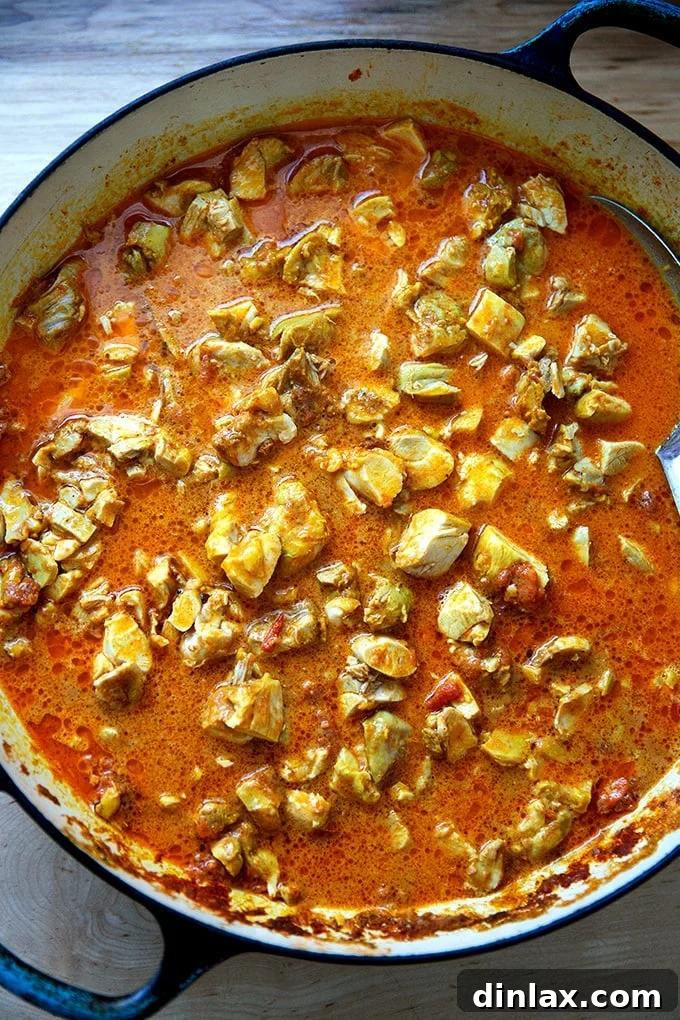 Effortless Butter Chicken and Chickpeas Instant Pot or Stovetop 24 A large braiser on the stovetop, filled with the finished stovetop butter chicken, showcasing its rich texture and color.