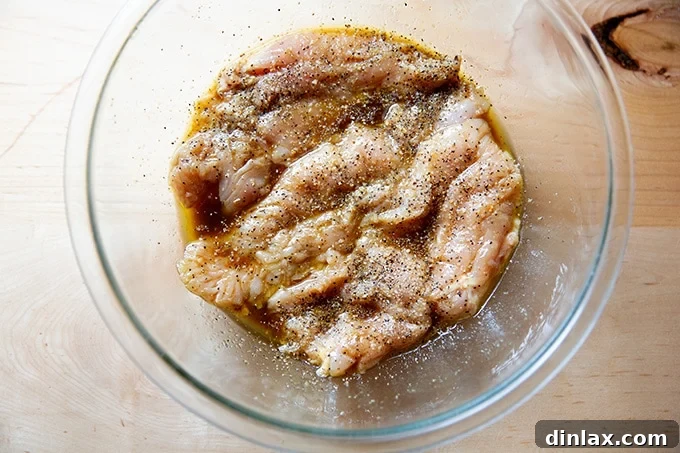 Simply Irresistible Grilled Chicken Breasts 11 Chicken breasts fully coated and marinating in the prepared mixture within a large bowl.