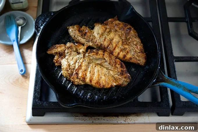 Simply Irresistible Grilled Chicken Breasts 13 Grilled chicken breasts cooking in a grill pan, showing developing grill marks.