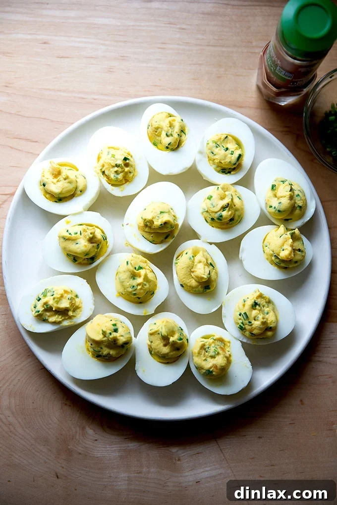 Timeless Deviled Delights 13 A plate of deviled eggs with the yolk filling neatly piped, awaiting garnish.