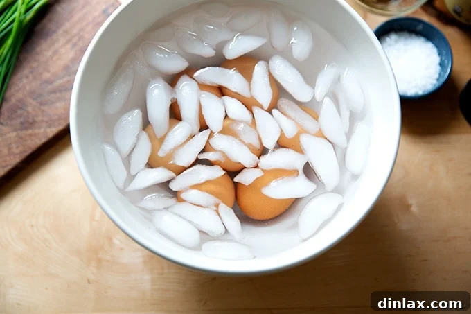 Timeless Deviled Delights 5 An ice bath filled with steaming hot eggs, quickly cooling them down.