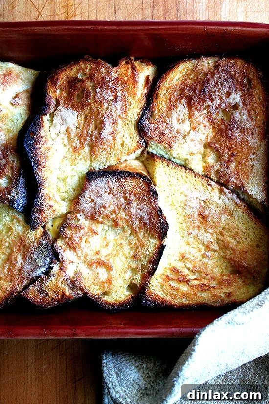 A close-up of the custardy interior of a baked French toast slice, showcasing its soft texture.
