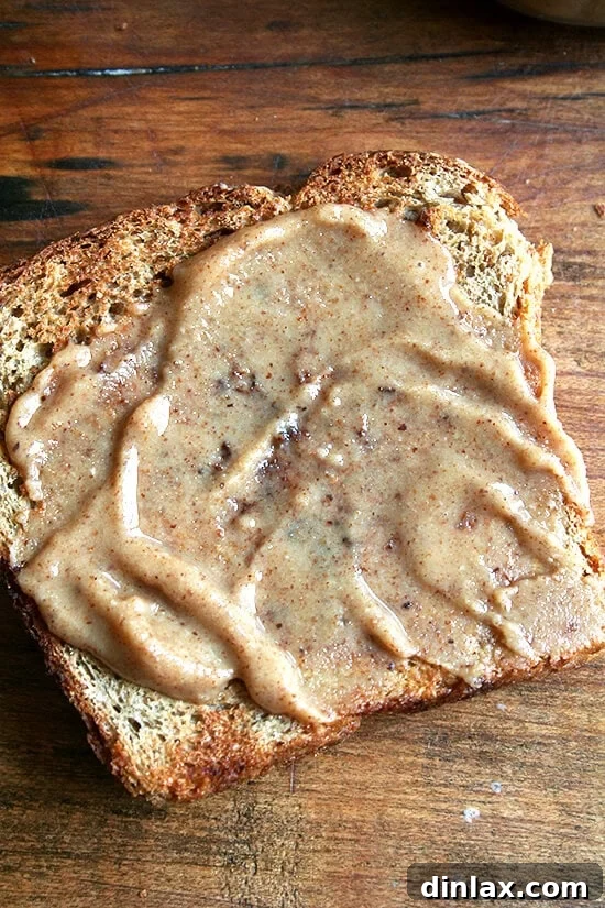 No-knead oatmeal bread topped with a generous spread of maple almond butter