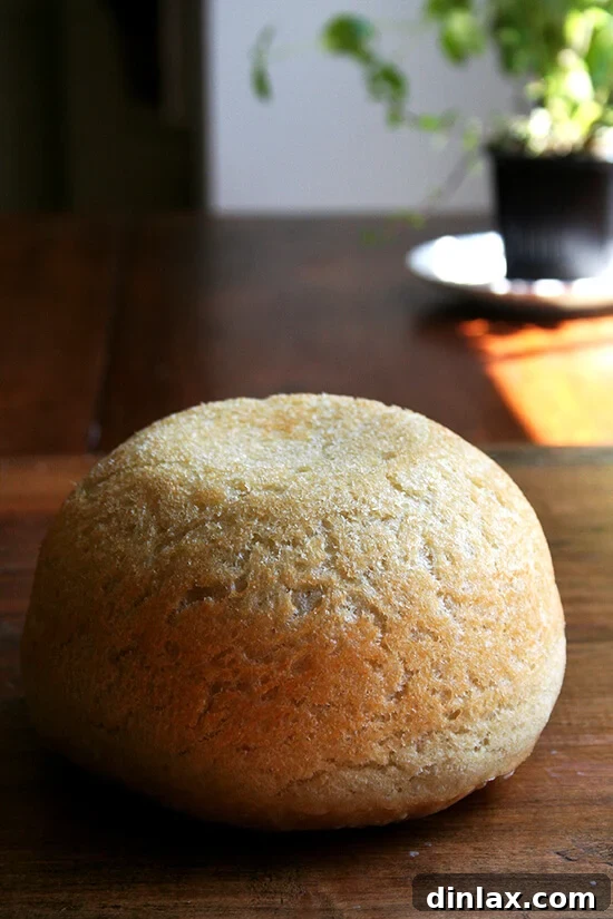 Sliced homemade peasant bread with a golden crust