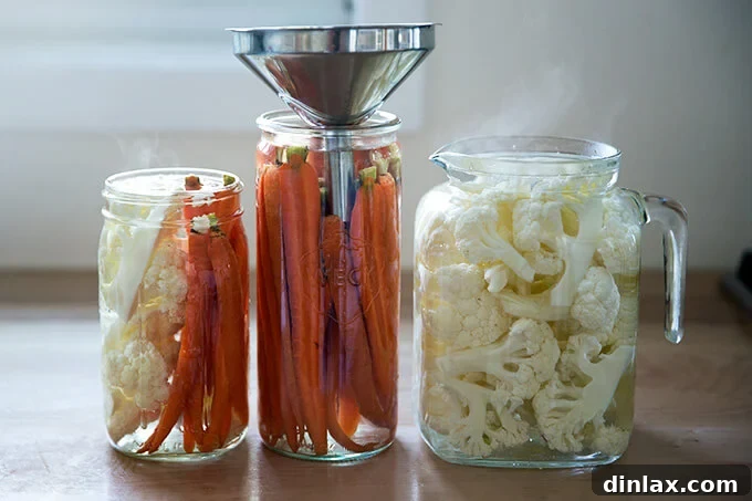 Assorted pickled crudités in elegant glass jars, ready for dipping.