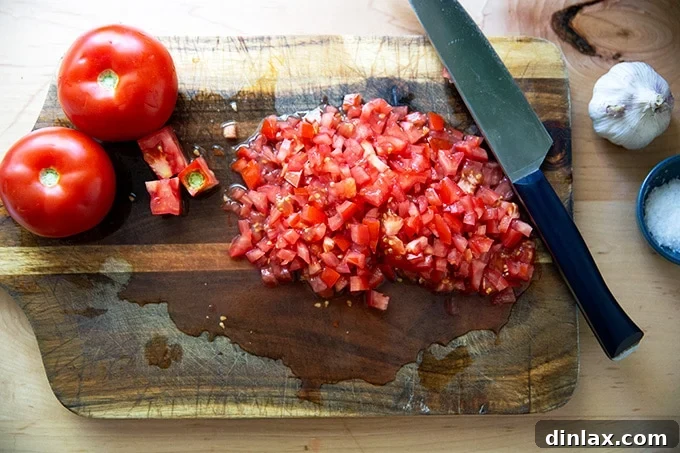 Homemade Trader Joe's Style Bruschetta Sauce 5 A cutting board with chopped tomatoes on top.