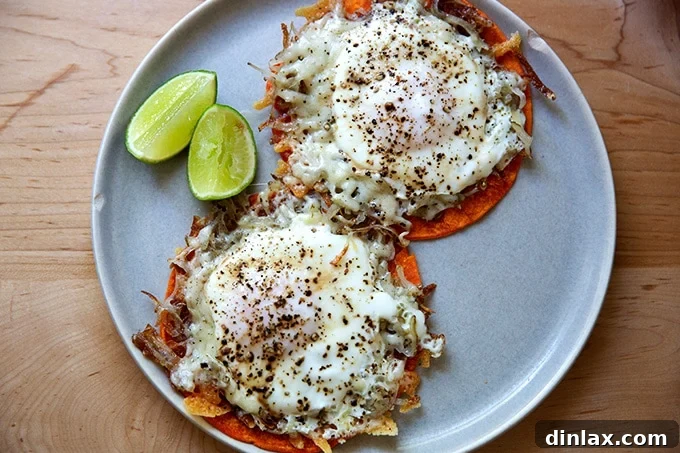 Two crispy potato, egg, and cheese rounds perfectly placed on warm tortillas on a plate, ready for garnishing.