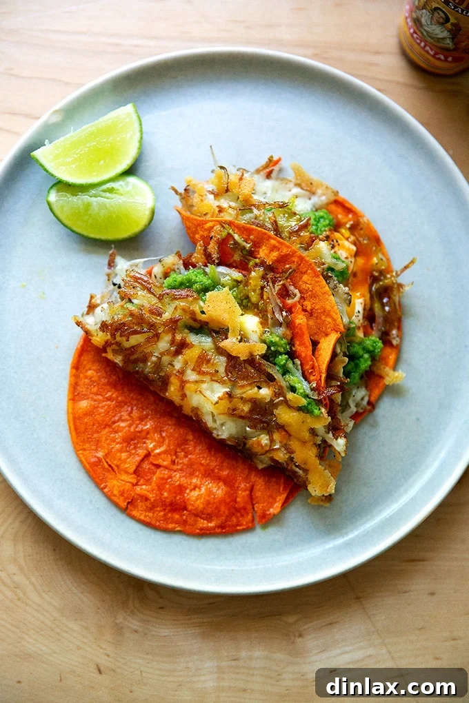 A close-up shot emphasizing the golden, ultra-crispy potato and cheese frico layer of a taco, promising an exquisite crunch.