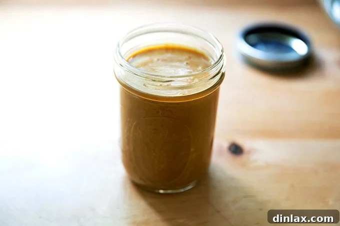 Refreshing Peanut Noodle Salad with Crisp Cucumbers 5 A glass jar filled with the prepared peanut dressing, showcasing its smooth texture and vibrant color, ready for storage in the fridge.