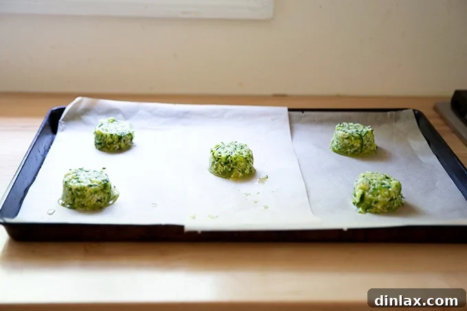 Zucchini tortilla batter mounds on a sheet pan.