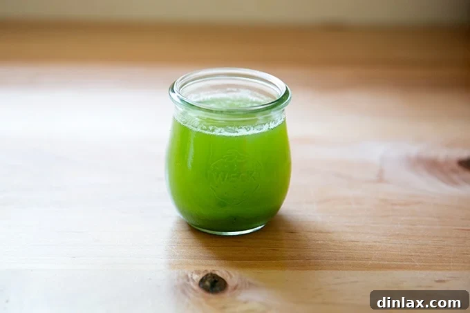 Drained zucchini liquid in a bowl.