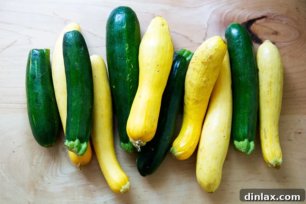 Zucchini Mastery: Margaret Roach's 20 Go-To Recipes 2 A generous harvest of fresh zucchini and vibrant summer squash displayed on a kitchen countertop, ready for cooking.