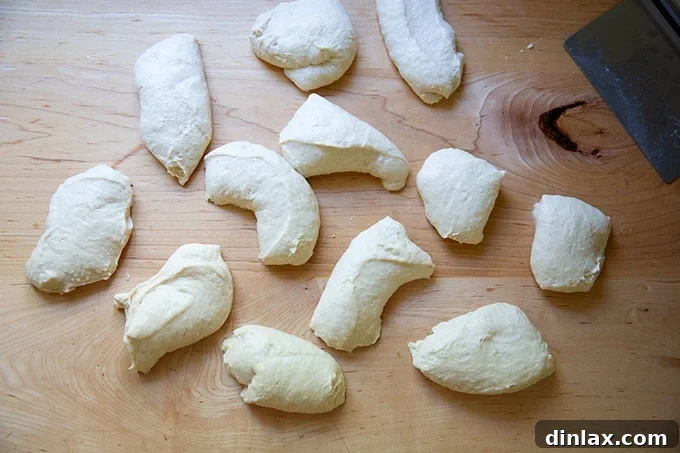 Pillowy Soft Pretzels Made Simple 13 Portioned soft pretzel dough pieces arranged on a countertop.