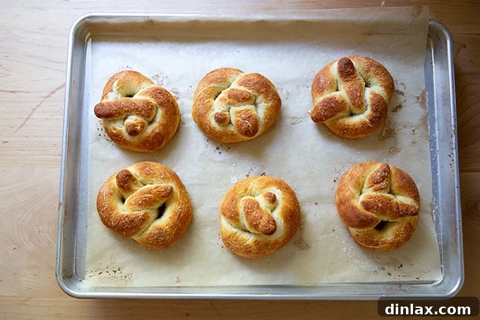 Pillowy Soft Pretzels Made Simple 24 Just-baked soft pretzels, golden brown and hot, on a sheet pan.