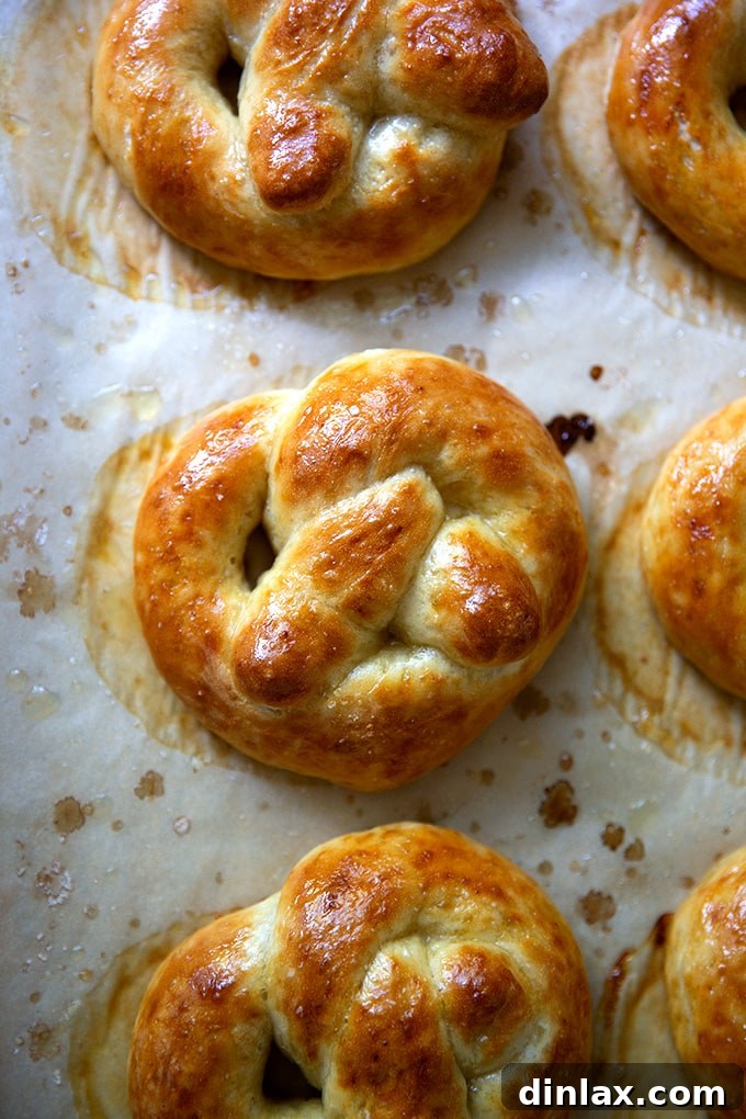 Pillowy Soft Pretzels Made Simple 26 Close-up of freshly baked soft pretzels on a sheet pan, heavily buttered.