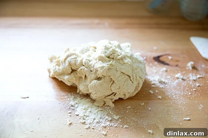 Pillowy Soft Pretzels Made Simple 7 Mixed pretzel dough on a countertop, just beginning to come together.