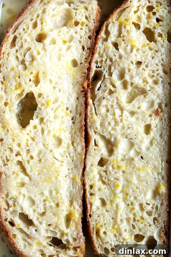 Thick bread slices soaking in a rich custard made with milk, eggs, sugar, and fragrant lemon zest, preparing for baking.