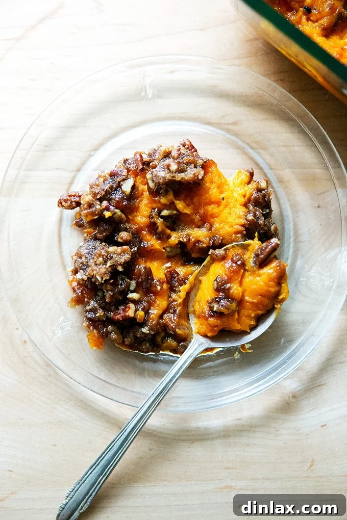 A scoop of sweet potato casserole on a plate.