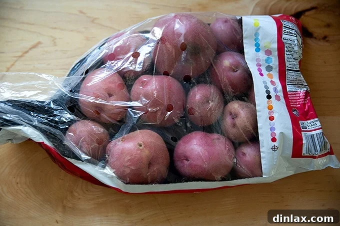 A rustic sack of vibrant red potatoes, ready for preparation.