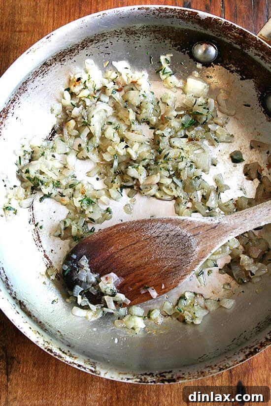 Sautéed shallots with butter and fresh thyme, caramelized to a golden-brown perfection, ready to be added to a grilled cheese.