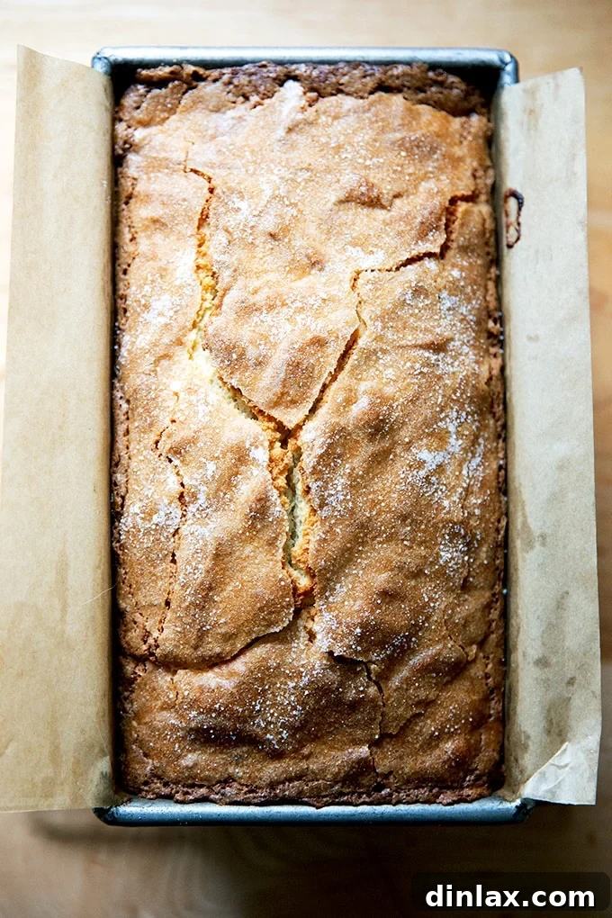 Freshly baked pound cake cooling on a wooden board, ready to be sliced and enjoyed.