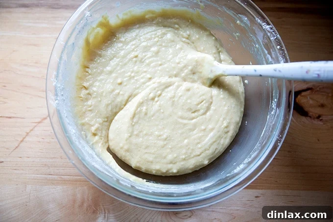 The finished, smooth pound cake batter filling a large bowl, ready to be transferred to the baking pan.