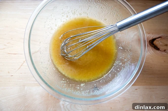 The mixture of whisked butter and sugar in a bowl, smooth and ready for the next additions.
